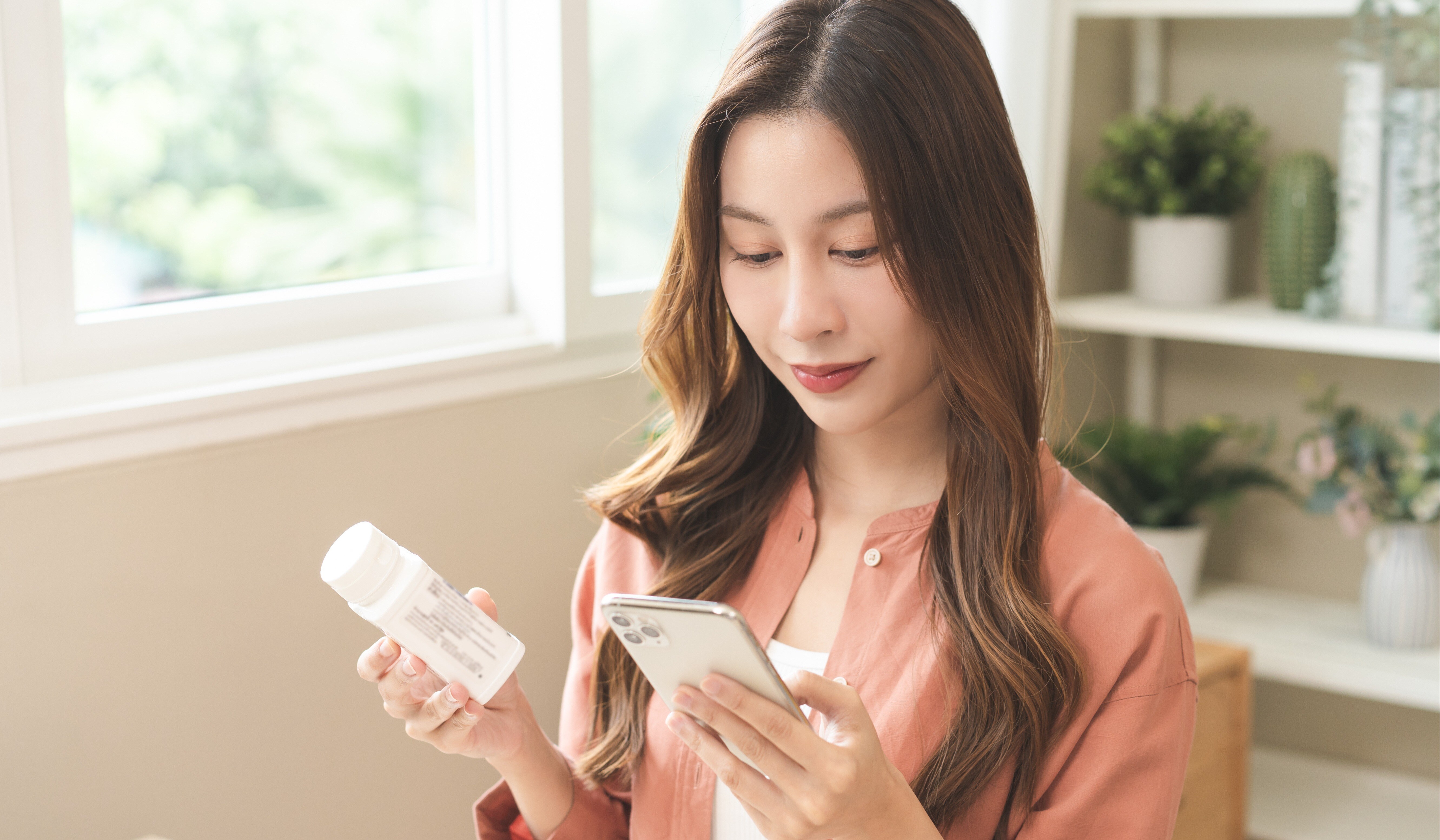 Woman holding medication bottle