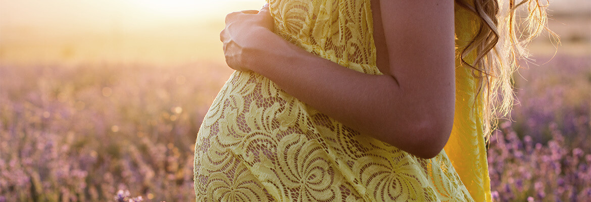 pregnant-woman-in-flower-field-compress